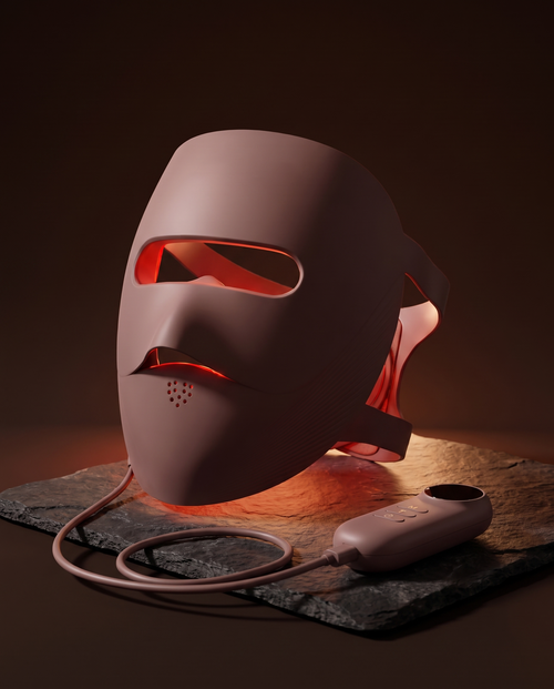 Clinaray LED light therapy mask in Brown with red light on, standing on a porcelain surface